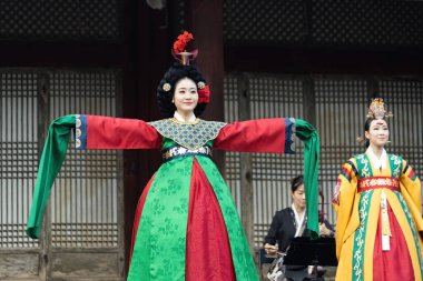 Korean woman dancer wearing traditional Korean clothing hanbok in the Gyeongbokgung palace in Seoul South Korea clipart