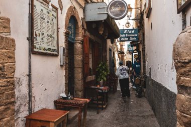 Narrow arch street in old town Medina in Essaouira Morocco clipart