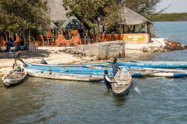 Senegali fisherman in the boat at Joal Fadiout island Senegal clipart