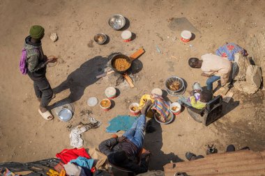 Top view of the poor family cooking food in the house yard on the fire in St. Louis, Senegal clipart