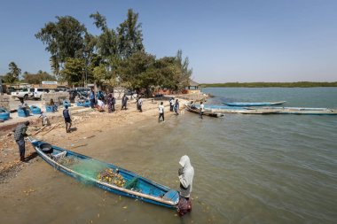 Senegali fisherman in the boat at Joal Fadiout island Senegal clipart