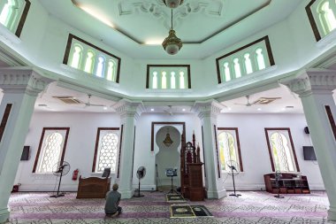 Müslüman adam Kuala Lumpur Malezya 'daki Mescidi Jamek camisinde namaz kılıyor