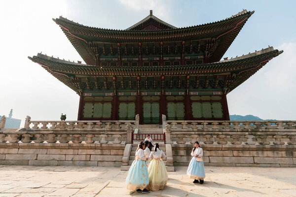 Beautiful Korean women wearing hanbok traditional dress visiting Gyeongbokgung Palace in Seoul South Korea