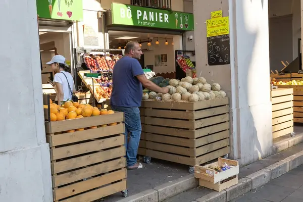 Nice France 'ın eski bir kasabasındaki meyve ve sebze dükkanında satıcı.