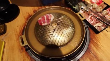 Top view of the traditional asian grill or hot pot in Thail restaurant cooking seafood and meat