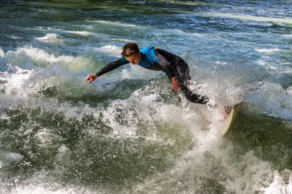 stock image Munich, Germany - Jun 04, 2022: Surfer in the city river, Munich is famous for people surfing in urban enviroment called Eisbach