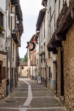 The old town of the medieval village of Covarrubias, Burgos, Castilla y Leon, Spain. Traditional streets with traditional patterns on the buildings walls in the medieval town