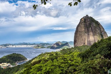 View of Guanabara Bay and Sugarloaf mountain with blue sky and mountains in Rio de Janeiro, Brazil, South America