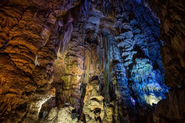 Gibraltar, United Kingdom - Nov 18, 2022: Upper Rock Nature Reserve at Gibraltar. Exploring Old St. Michaels Cave, that has been illuminated with colorful LED lighting, located at the Upper Rock Nature Reserve at Gibraltar.