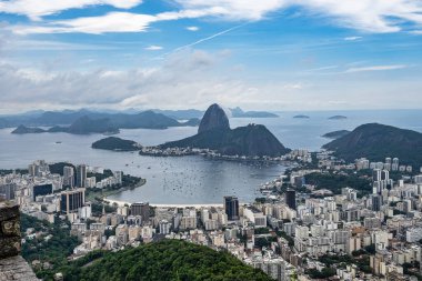 View from Mirante Dona Marta of Guanabara Bay and Sugarloaf mountain with blue sky and mountains in the background and Atlantic Ocean in Rio de Janeiro, Brazil, South America