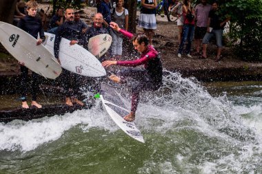 Münih, Almanya - Haziran 04, 2022: Şehir Nehrinde Sörfçü, Münih 'te Eisbach adı verilen kentsel çevrede sörf yapan insanlarla ünlüdür.