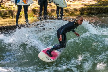 Münih, Almanya - Haziran 04, 2022: Şehir Nehrinde Sörfçü, Münih 'te Eisbach adı verilen kentsel çevrede sörf yapan insanlarla ünlüdür.