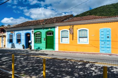 Old colorful houses in colonial Portuguese architecture in Ribeirao da Ilha, Florianopolis, Santa Catarina, Brazil. clipart