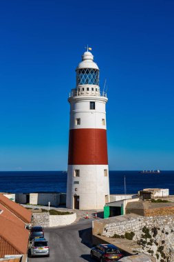 Gibraltar, United Kingdom - Nov 18, 2022: Europa Point Lighthouse, Trinity Lighthouse or Victoria Tower. Strait of Gibraltar on the background. British Overseas Territory of Gibraltar.