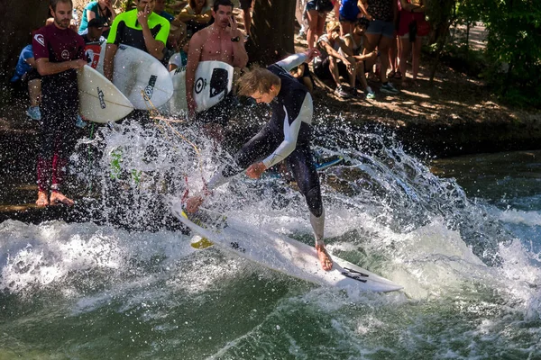 stock image Munich, Germany - Jun 04, 2022: Surfer in the city river, Munich is famous for people surfing in urban enviroment called Eisbach