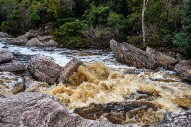 View of the river Mucugezinho with running water, forming a waterfall and Poco do Pato, in Chapada Diamantina, Bahia, Brazil