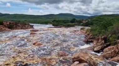 Donana Waterfall in Paraguassu River with dark waters due to iron ore in Andarai, Chapada Diamantina, Bahia in Brazil