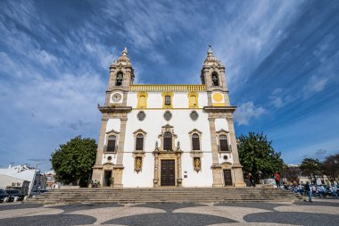 Facade of Carmo Church in Faro Portugal, Igreja da Ordem Terceira de Nossa Senhora do Monte do Carmo. The Igreja do Carmo in Faro, with its twin bells towers is an ancient Church in the Algarve. clipart