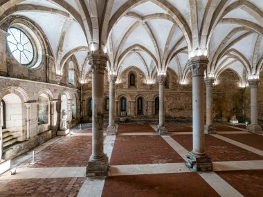 The dining room of Alcobaca monastery, Mosteiro de Santa Maria de Alcobaca at Alcobaca, Portugal. A big gothic room where the monks ate together, inside Monastery. clipart