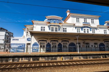 Geleneksel Portekiz 'deki yaşam hikayesini anlatan tipik mavi azulejos fayanslarıyla süslenmiş eski Aveiro tren istasyonunun dış görünüşü.