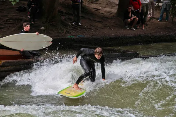 stock image Munich, Germany - Jun 04, 2024: Surfer in the city river, Munich is famous for people surfing in urban enviroment called Eisbach