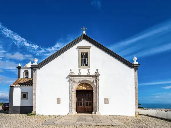 stock image The church of Cacela Velha in southern Portugal. White facades of houses with colored decorations. Typical Algarve church