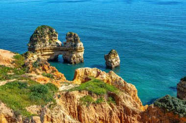 Ponta da Piedade is a unique rock formation with famous grottos in the ocean at Lagos, Algrave, Portugal. Number one attraction in Portugal clipart