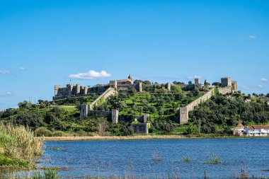 The village of Montemor-o-Velho in Portugal is crowned by its imposing castle, the main fortress of the Baixo Mondego in medieval times clipart