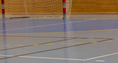 Handball goal and hall floor in a sports hall with various lines
