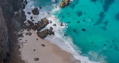 Steep cliffs and turquoise sea at the Cape of Good Hope in South Africa