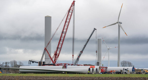 Wind energy company Vestas with a red crane during the construction of an onshore wind farm
