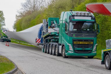 Hamburg, Germany - May 01, 2023: Heavy transport of rotor blades of a wind turbine, break time at a rest area near Hamburg clipart