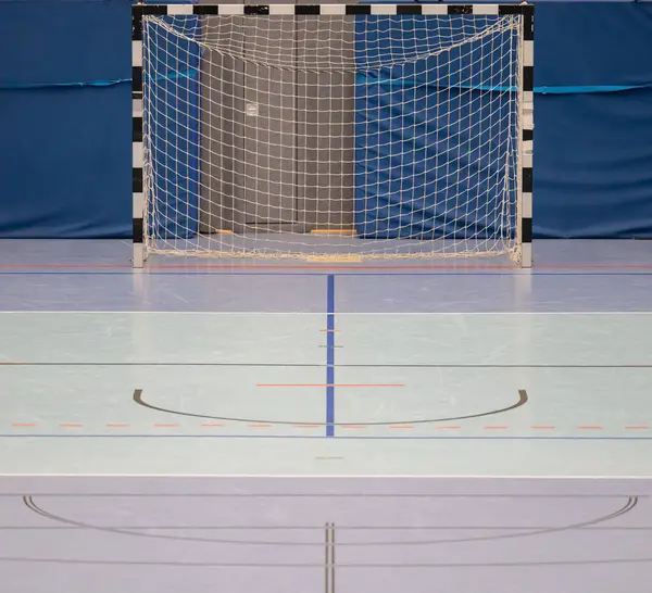 Handball goal and hall floor in a sports hall with various lines