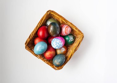 Colorful Easter eggs in a basket. Traditional festive decor.