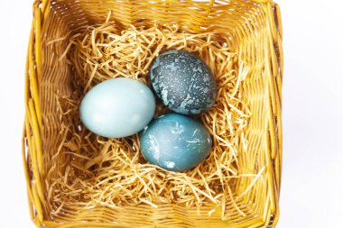 Colorful Easter eggs in a basket. Traditional festive decor.