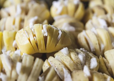 Baked potatoed with bacon, garlic and species. Sliced vegetables.
