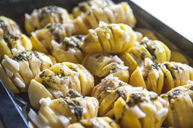 Baked potatoed with bacon, garlic and species. Sliced vegetables.