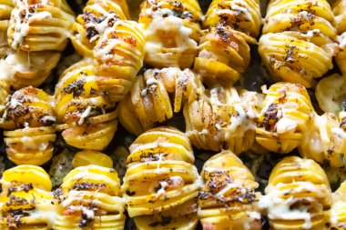 Baked potatoed with bacon, garlic and species. Sliced vegetables.