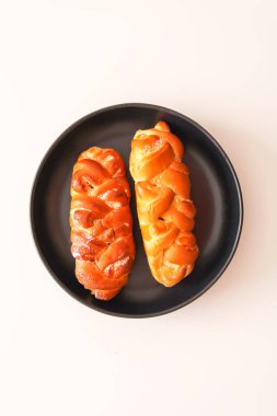 Freshly baked sweet buns. Homemade pastry on white background.