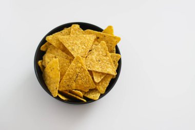 Tortilla chips in a black ceramic plate.