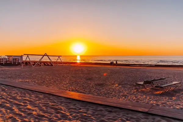 stock image Baltic sea at sunset. Sandy beach in a warm golden evening light.