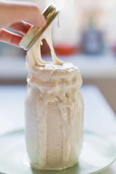 Starter sourdough in glass jar, healthy food concept