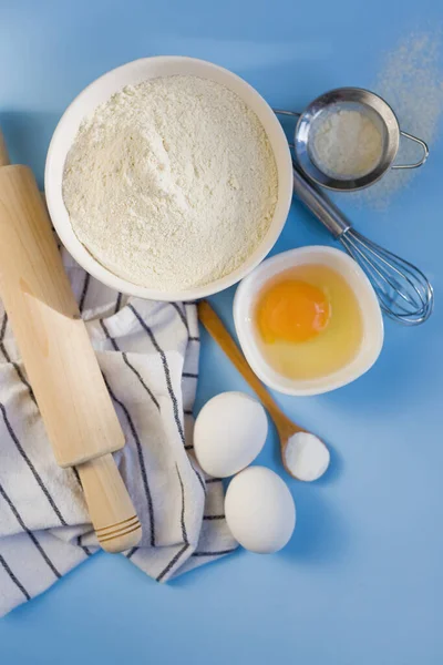 Ingredients Baking Blue Background Flour Bowl Eggs Baking Powder Kitchen — Stock Photo, Image
