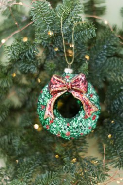 Green spruce fir tree branch, Christmas lights garland and vintage wreath decoration. Christmas background with copy space