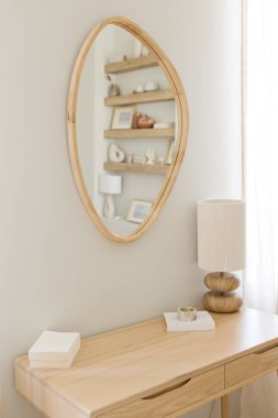 Lamp and mirror on a wooden table