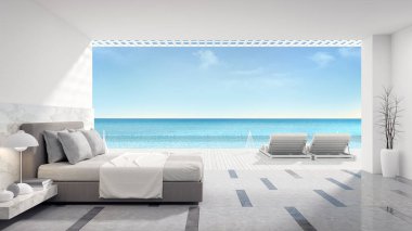 Modern yatak odası, güneşlenme güvertesi ve plaja yakın özel yüzme havuzu ve lüks bir evde panoramik deniz manzarası.