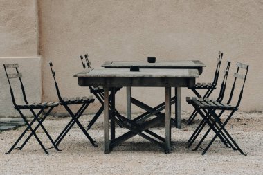 Empty tables on the gravel patio