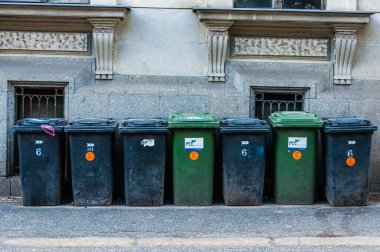 Liberec, Czech Republic - May 18, 2019 - Green and black trash bins on the street