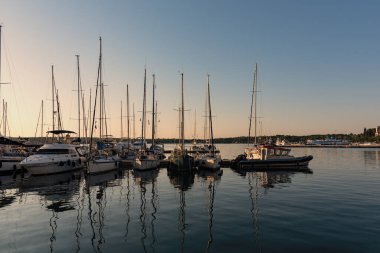 Pula, Croatia - Aug 20, 2019 - Spectacular sunset in Pula, small private yachts in the shadows