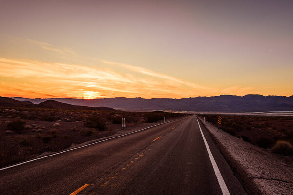 Death valley empty highway during sunset